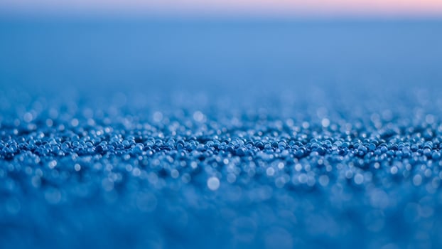 A close up of a blue surface with water droplets photo