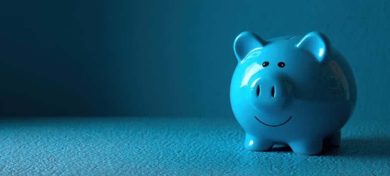 The cheerful blue piggy bank on a vibrant background. photo