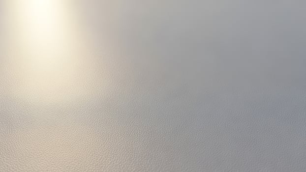 A white surface with a light shining through it photo