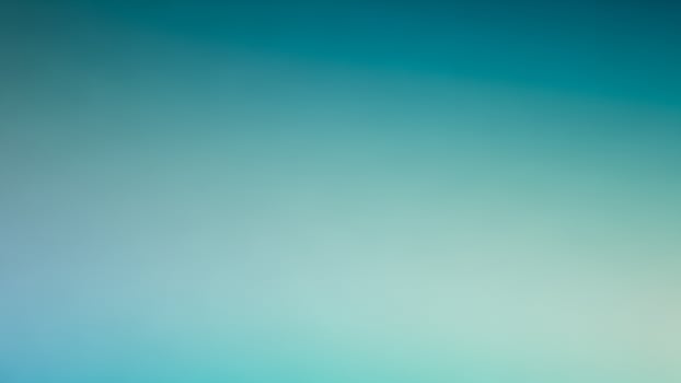 A blue and green blurred background with a white object photo