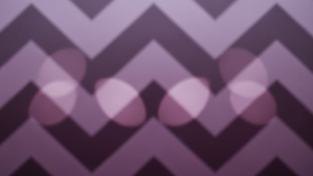 A purple and black chevron pattern with some lights photo