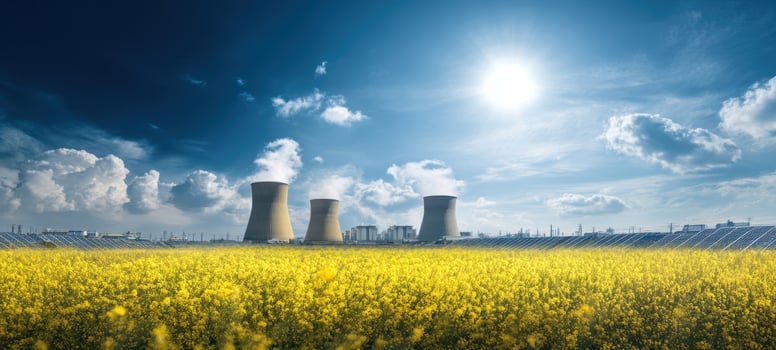 The vibrant yellow field with nuclear power plant and solar panels under bright sky photo