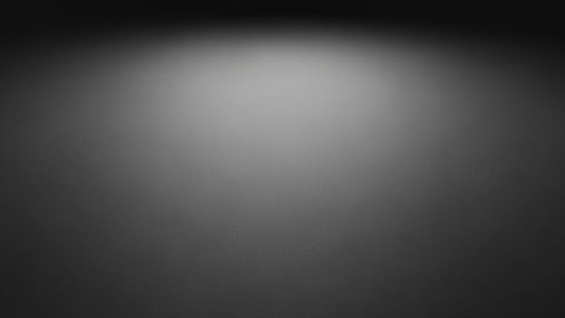 Black and white photo of a dark room with a light