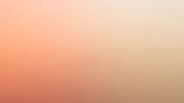 A blurry orange and pink background with a blurred sky photo