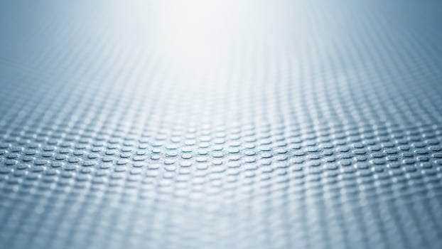 A close up of a metal surface with a light background photo
