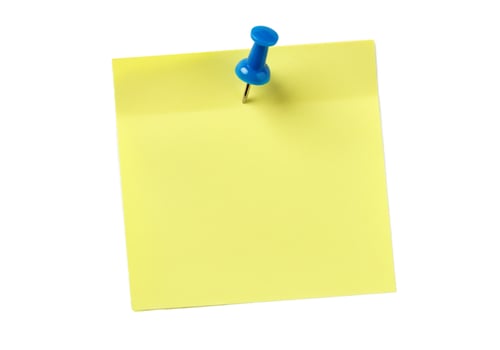 Yellow sticky note pinned with blue pushpin on white background for message or reminder photo