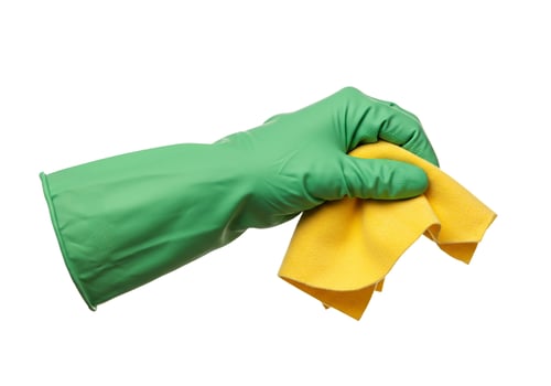 Hand in green glove holding yellow cleaning cloth isolated on white background depicts work and sanitation photo