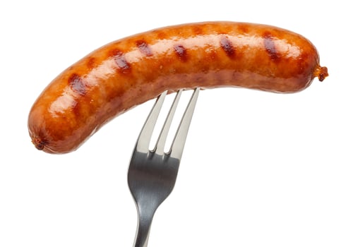 Grilled sausage on fork culinary food preparation simple still life photo