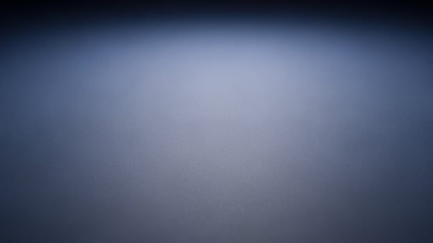 A dark blue background with a light in the middle photo