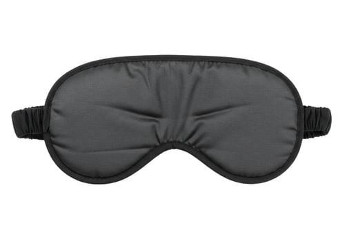 Black satin sleep mask eye protection isolated on white background photo