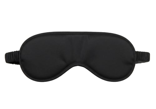 Black eye mask for sleeping and relaxation on white background photo