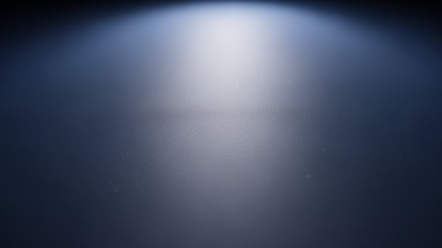A light beam shines through a dark room photo