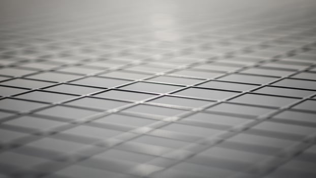 A close up of a metal grid with a light shining on it photo