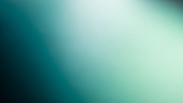 A green and blue light is shining on a black background photo