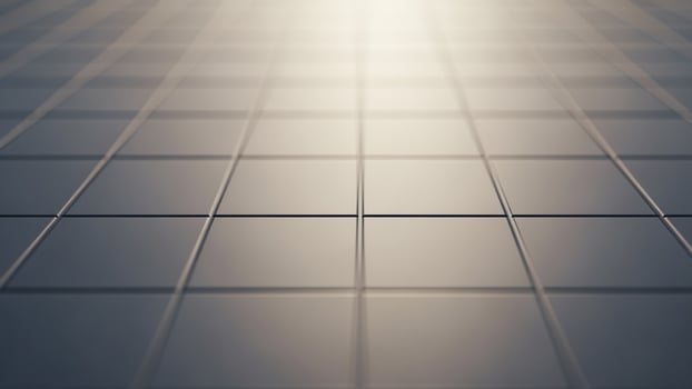 An abstract image of a tiled floor with light shining through photo