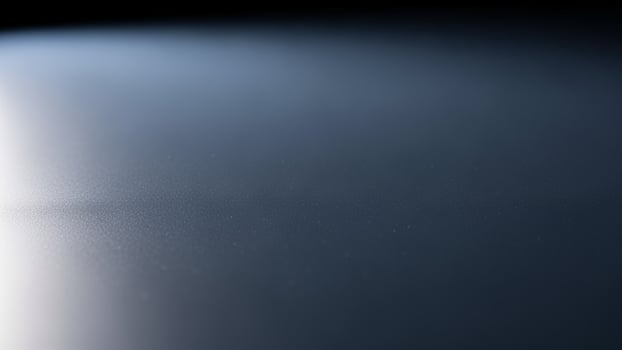 A close up of a light shining on a dark surface photo