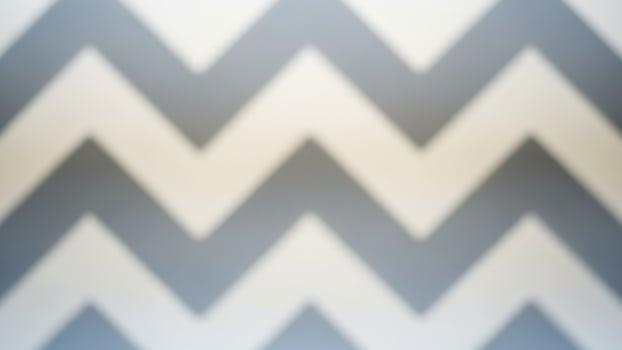 A gray and white chevron pattern on a wall photo