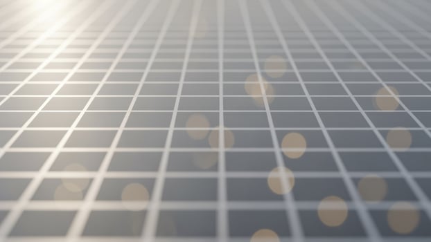 A grid of squares with light shining on them photo