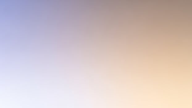 A blurry background with a blue sky and orange clouds photo