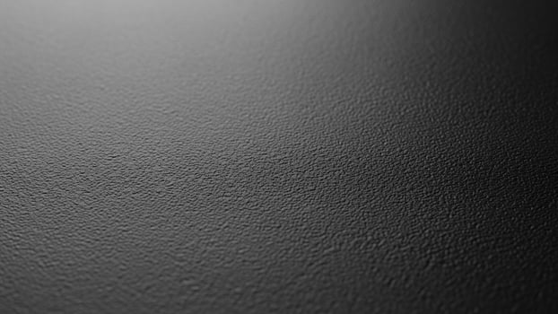 Black and white photo of a wall with a black background