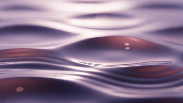 Water waves on a surface with purple color photo
