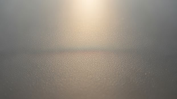 A blurry image of a light shining through a window photo
