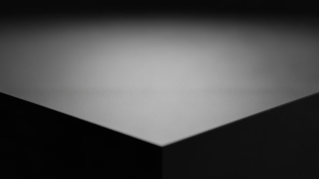 Black and white photo of a cube on a table