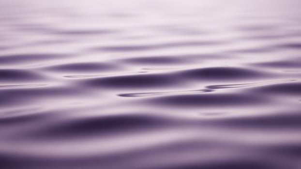 Water ripples on the surface of a purple lake photo