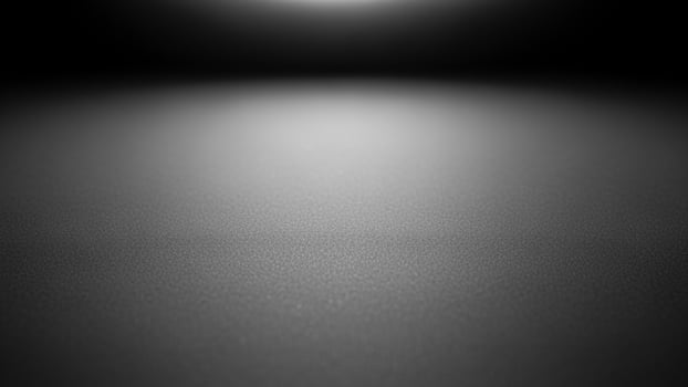 Black and white photo of a spotlight shining on a dark surface