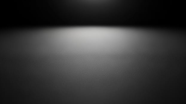 Black and white photo of a spotlight on a dark floor