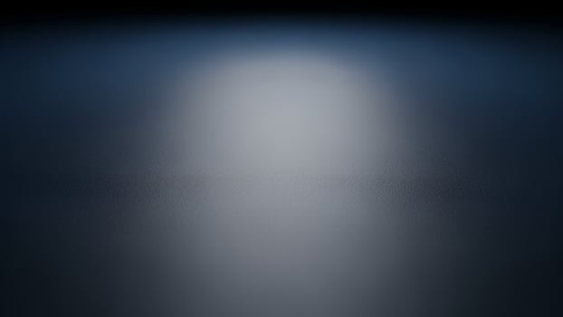 A dark background with a light coming from the top photo