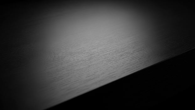 Black and white photo of a table with a dark background