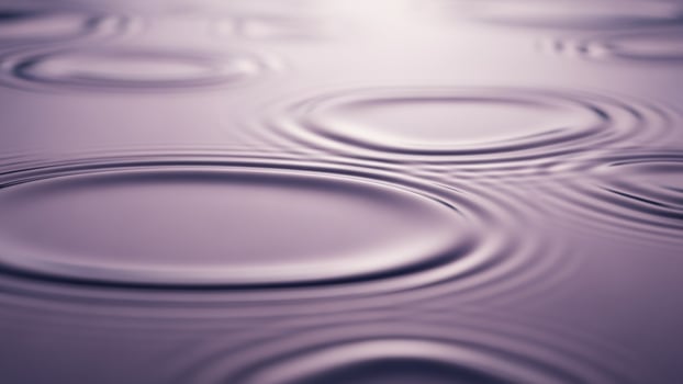 Water drops on a surface with a purple background photo