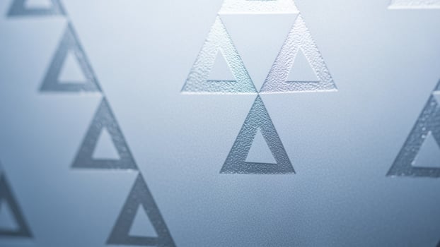 A close up of a glass window with a pattern of triangles photo