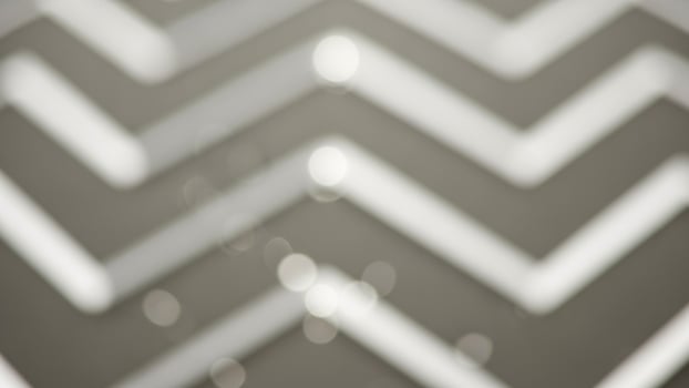 A white and gray chevron pattern on a wall photo