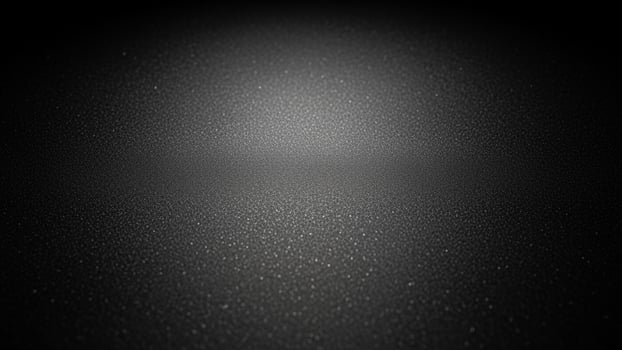 Black background with a light shining on it background. photo