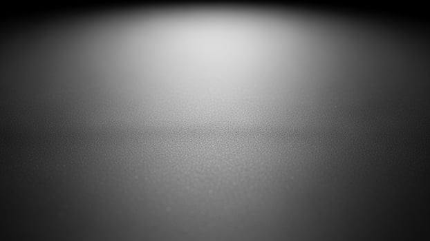 Black and white photo of a dark room with light coming from the ceiling background
