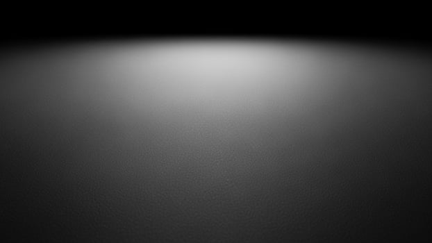 Black and white photo of a dark room with light