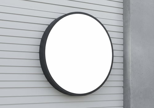 Blank round signboard on wooden wall for customizable message photo