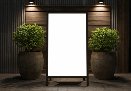 Blank sign with potted plants for custom messaging and advertising photo
