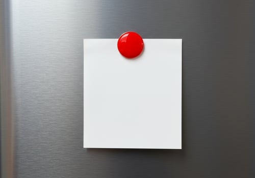 Note card with red magnet on metal surface reminder or message template photo