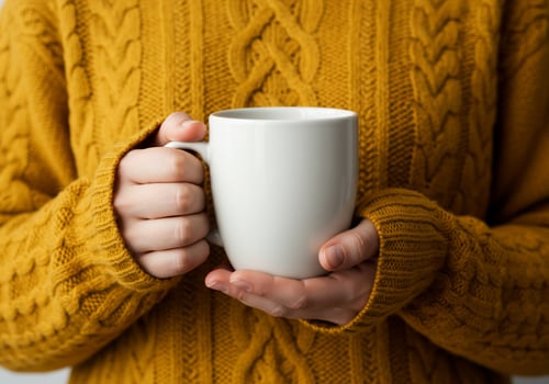 Person hold mug in cozy sweater warm drink concept photo