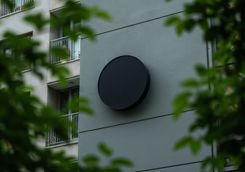 Round sign mockup on building facade urban environment photo