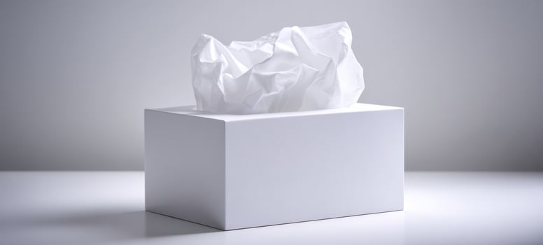 The elegant white tissue box with crumpled paper suggesting comfort and simplicity. photo