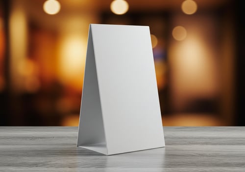 White table tent card mockup for display on textured surface photo