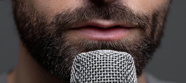 The close-up of a man speaking into a microphone with passion. photo