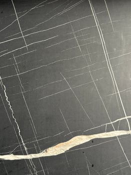 Natural stone surface with organic crack lines for imperfect minimalist wabi sabi design background modern interior inspiration raw texture emotional storytelling visual with serene tones photo
