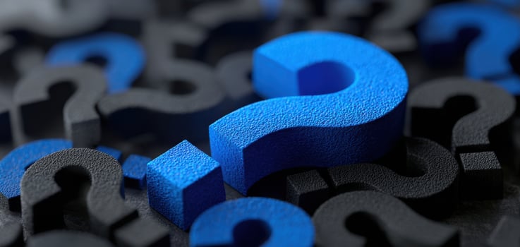 The blue question mark standing out among black symbols of inquiry photo