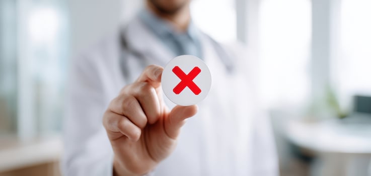 The doctor holding a warning sign to emphasize health and safety concerns. photo