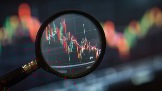 The magnifying glass focusing on stock market trends and data analysis. photo